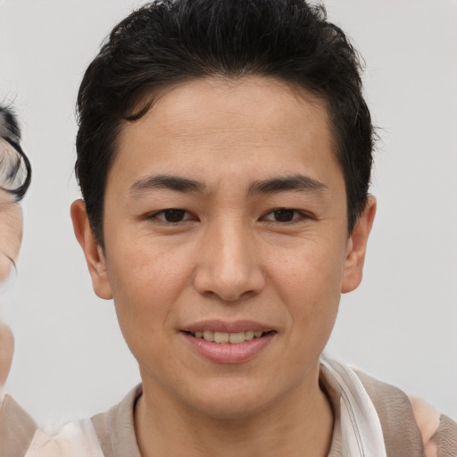 Joyful asian young-adult male with short  brown hair and brown eyes