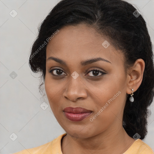 Joyful black young-adult female with long  brown hair and brown eyes