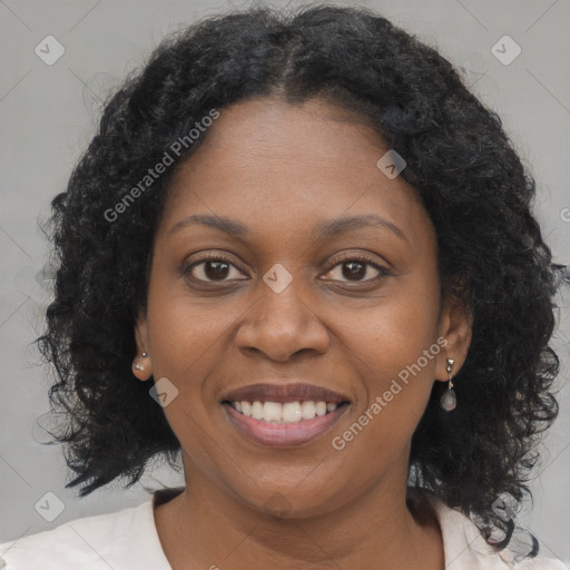 Joyful black young-adult female with long  brown hair and brown eyes