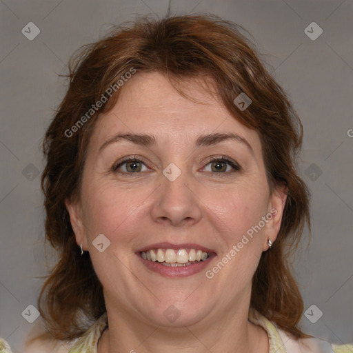 Joyful white adult female with medium  brown hair and blue eyes