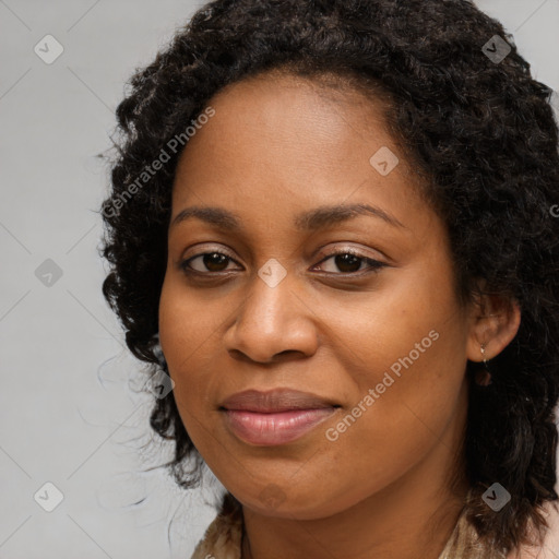 Joyful black young-adult female with long  brown hair and brown eyes