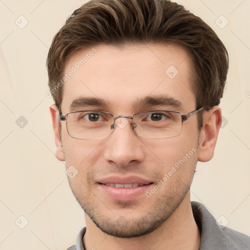 Joyful white young-adult male with short  brown hair and grey eyes