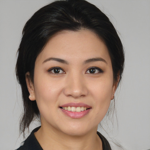 Joyful asian young-adult female with medium  brown hair and brown eyes