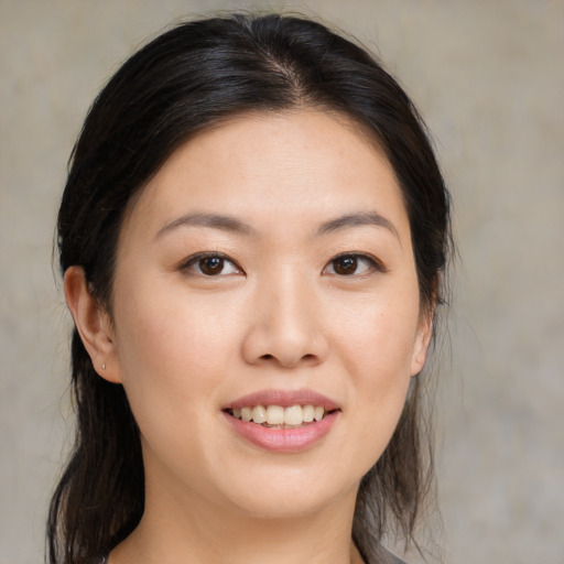 Joyful asian young-adult female with medium  brown hair and brown eyes
