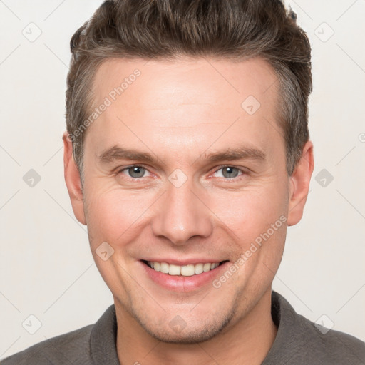 Joyful white adult male with short  brown hair and grey eyes