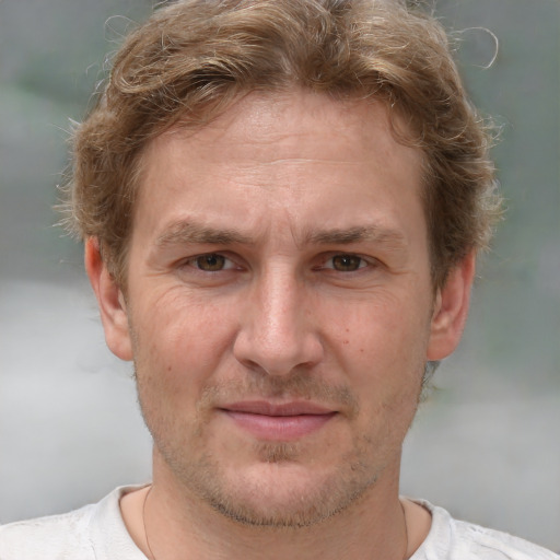 Joyful white adult male with short  brown hair and grey eyes