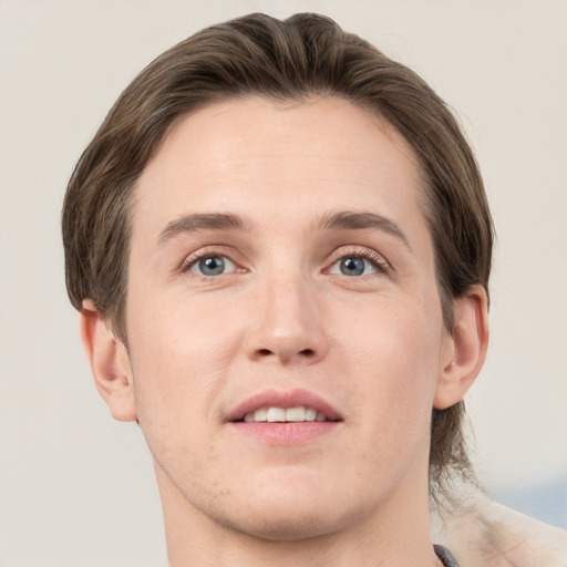 Joyful white young-adult male with short  brown hair and grey eyes