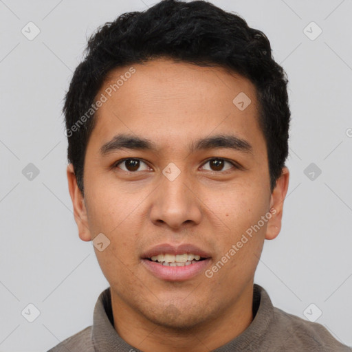 Joyful latino young-adult male with short  black hair and brown eyes