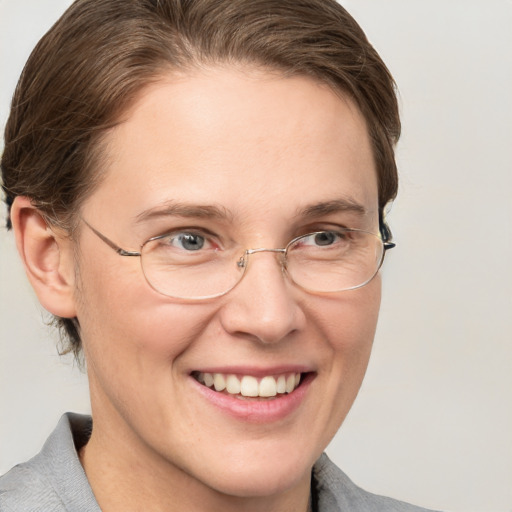 Joyful white adult female with medium  brown hair and grey eyes