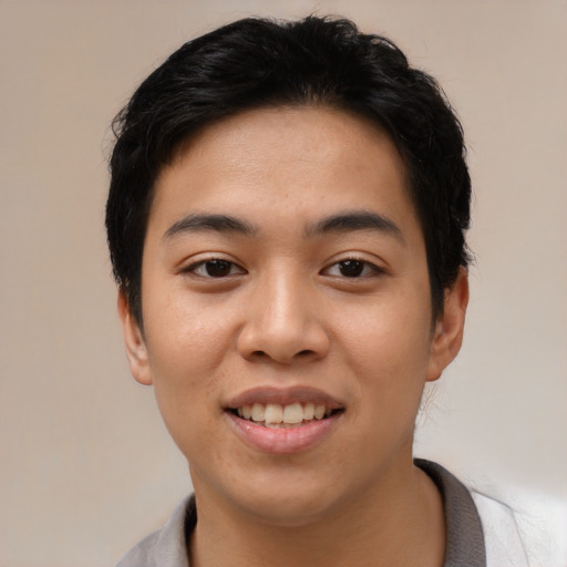 Joyful asian young-adult female with short  black hair and brown eyes