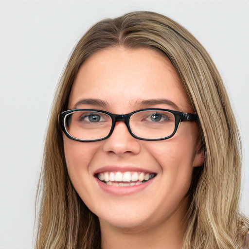 Joyful white young-adult female with long  brown hair and green eyes