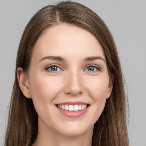 Joyful white young-adult female with long  brown hair and grey eyes