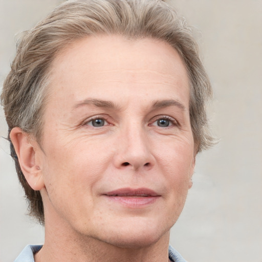 Joyful white adult female with short  brown hair and grey eyes