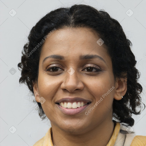 Joyful black young-adult female with long  brown hair and brown eyes