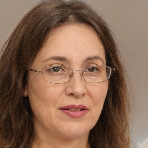 Joyful white adult female with long  brown hair and brown eyes