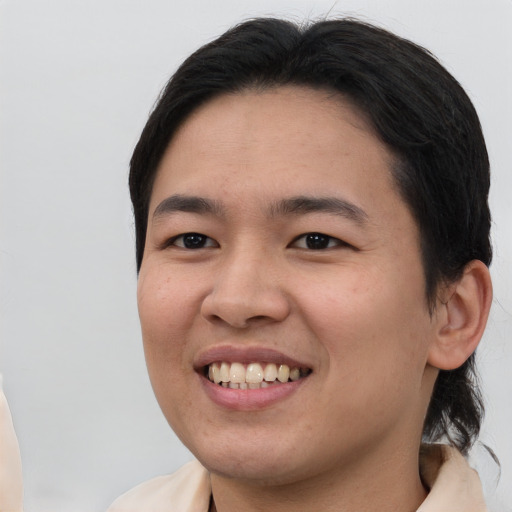 Joyful asian young-adult female with short  brown hair and brown eyes