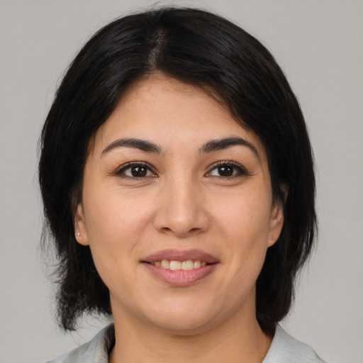 Joyful asian young-adult female with medium  black hair and brown eyes