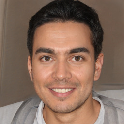 Joyful white young-adult male with short  black hair and brown eyes