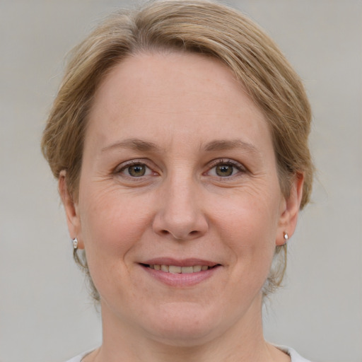 Joyful white adult female with medium  brown hair and blue eyes