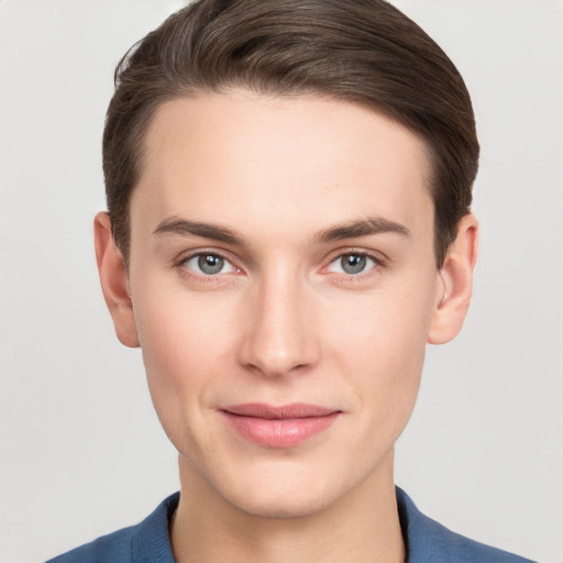 Joyful white young-adult male with short  brown hair and grey eyes