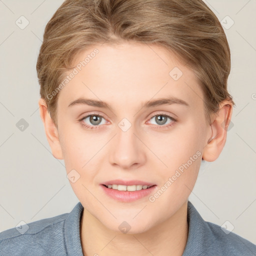 Joyful white young-adult female with short  brown hair and blue eyes