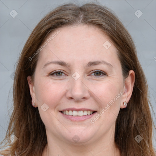 Joyful white adult female with long  brown hair and grey eyes