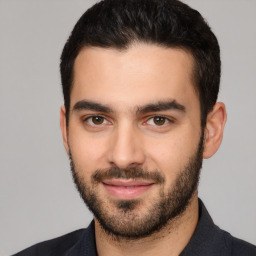 Joyful white young-adult male with short  black hair and brown eyes