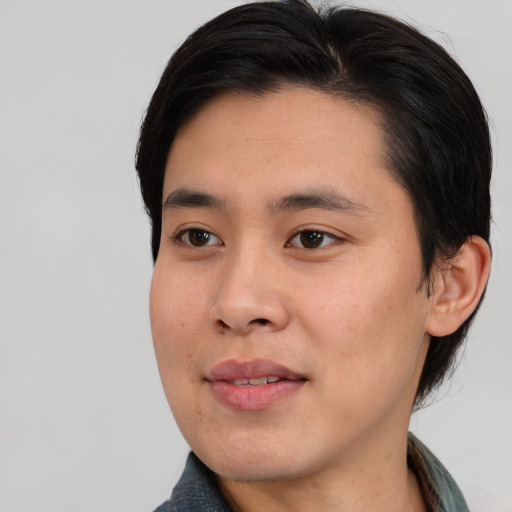 Joyful asian young-adult male with medium  black hair and brown eyes
