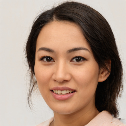 Joyful asian young-adult female with medium  brown hair and brown eyes