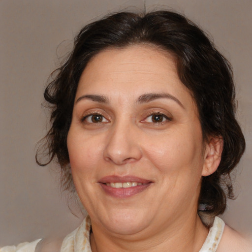 Joyful white adult female with medium  brown hair and brown eyes