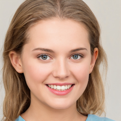 Joyful white young-adult female with medium  brown hair and green eyes