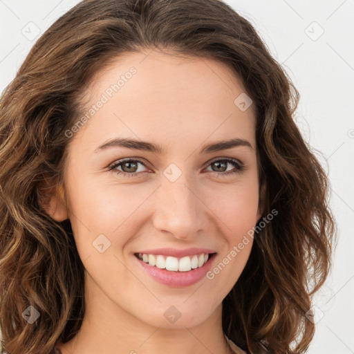 Joyful white young-adult female with long  brown hair and green eyes