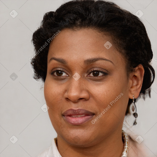 Joyful black adult female with short  brown hair and brown eyes