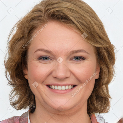 Joyful white adult female with medium  brown hair and blue eyes