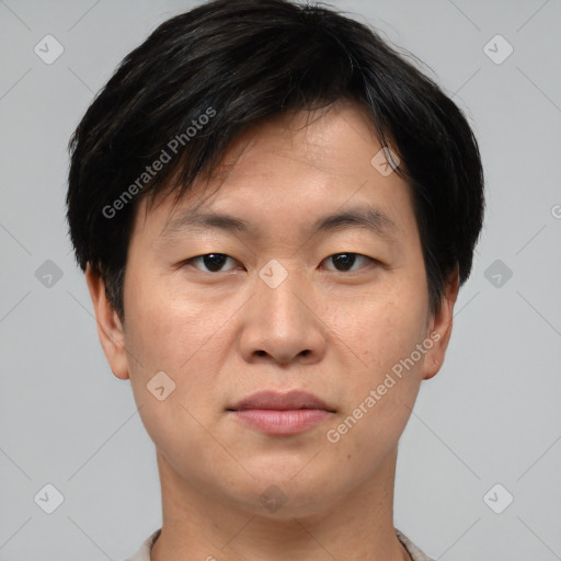 Joyful asian young-adult male with short  brown hair and brown eyes