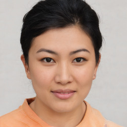 Joyful asian young-adult female with short  brown hair and brown eyes