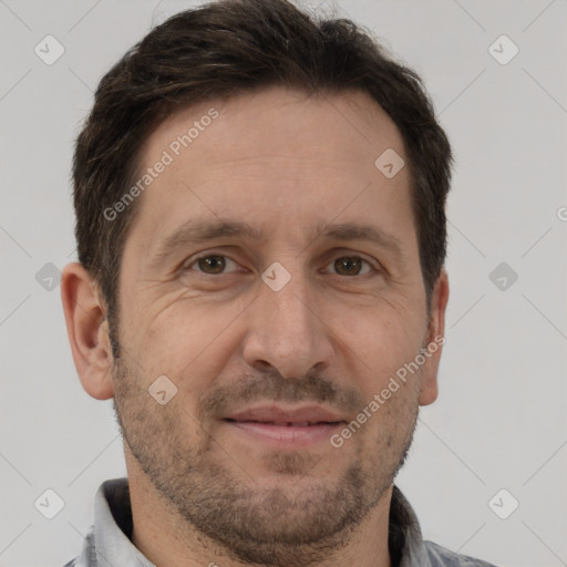 Joyful white adult male with short  brown hair and brown eyes