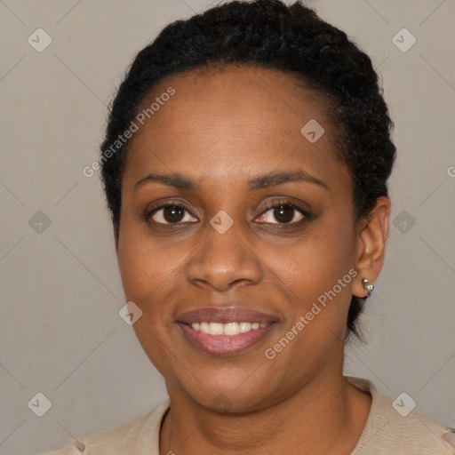 Joyful black young-adult female with short  black hair and brown eyes