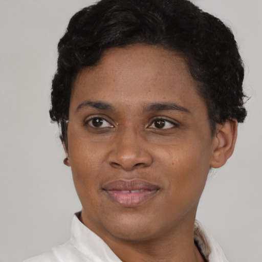 Joyful black young-adult female with short  black hair and brown eyes