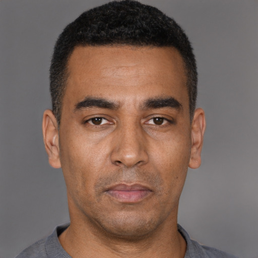 Neutral latino adult male with short  black hair and brown eyes