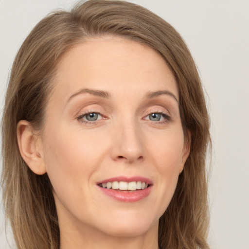 Joyful white young-adult female with long  brown hair and grey eyes