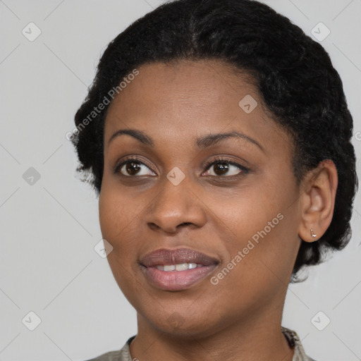 Joyful black young-adult female with short  black hair and brown eyes