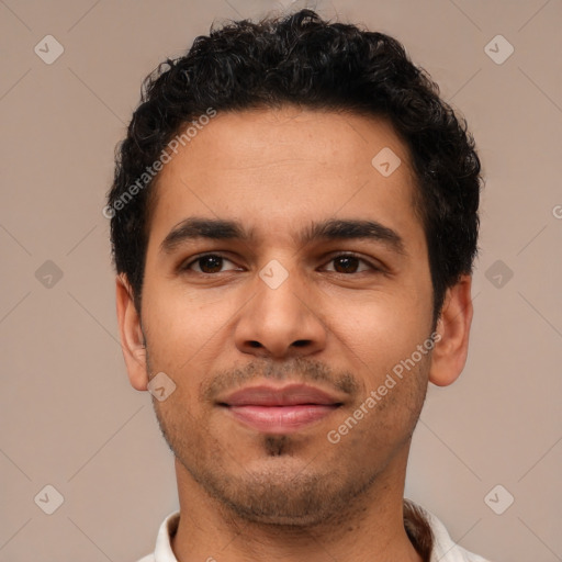 Joyful latino young-adult male with short  brown hair and brown eyes
