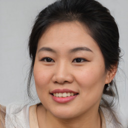 Joyful asian young-adult female with medium  brown hair and brown eyes