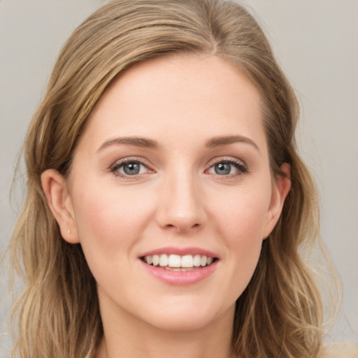 Joyful white young-adult female with long  brown hair and green eyes