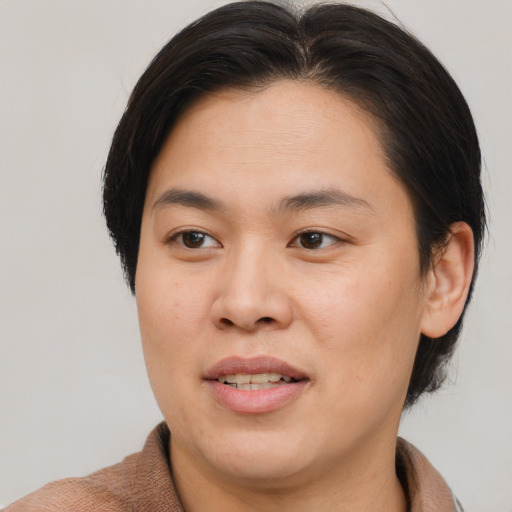 Joyful asian young-adult female with short  brown hair and brown eyes