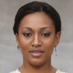 Joyful black young-adult female with short  brown hair and brown eyes