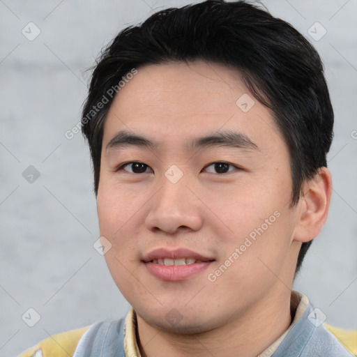Joyful asian young-adult male with short  black hair and brown eyes
