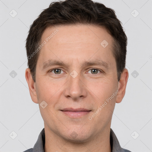 Joyful white adult male with short  brown hair and brown eyes