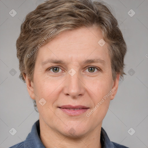 Joyful white adult female with short  brown hair and grey eyes